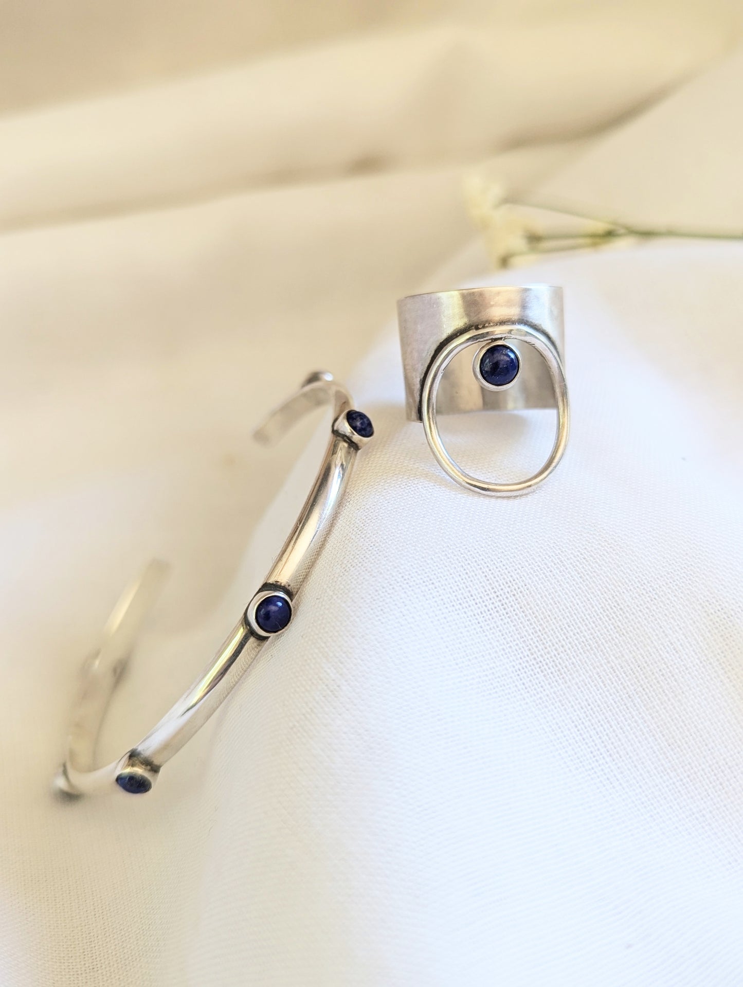 Sterling silver ring and matching bracelet handcrafted jewelry, each with Lapis lazuli gemstone. Minimalist and elegant designed with a simple touch. Made in California by designer jewelry