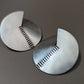 Brushed and stamped silver 925 circular earrings with subtle notch and linear pattern. Modern and élégant handcrafted jewelry by Anajo Designs, made in California.