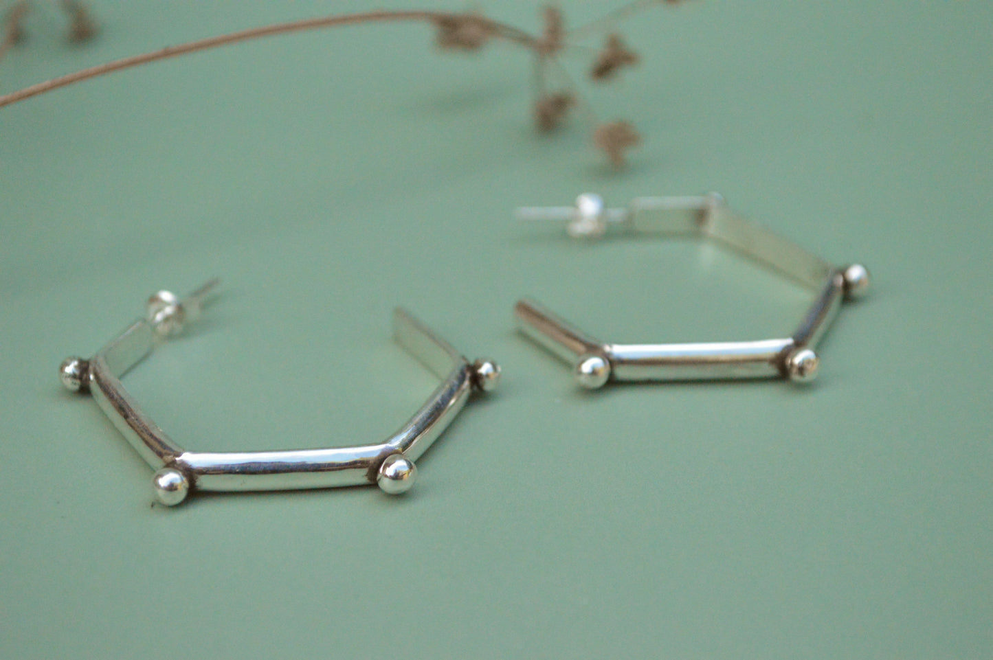 mordern sterling silver hoops in hexagonal shape and lightweight. Handmade by designer made in California  