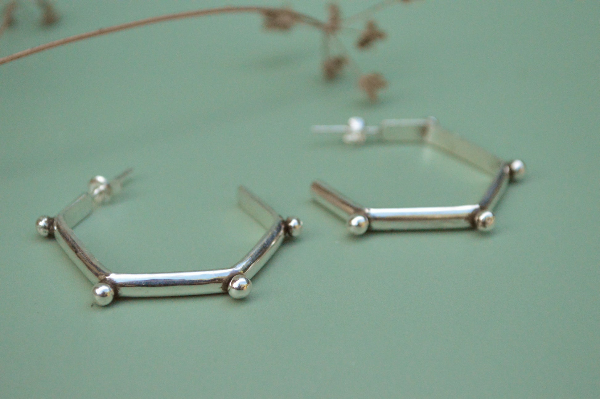 mordern sterling silver hoops in hexagonal shape and lightweight. Handmade by designer made in California  