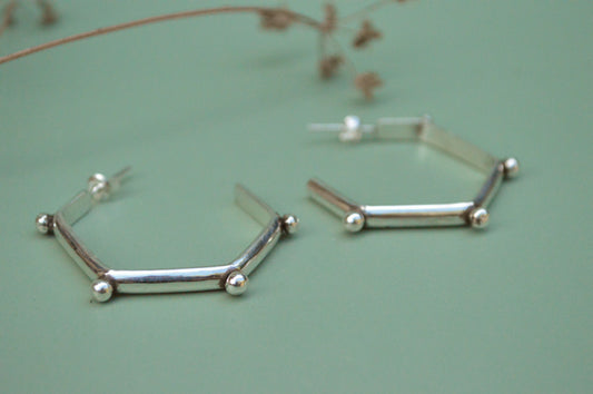 mordern sterling silver hoops in hexagonal shape and lightweight. Handmade by designer made in California  