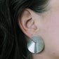 Model wearing brushed silver sterling earrings with notch and line detail.  Artisan minimalist silver jewelry.